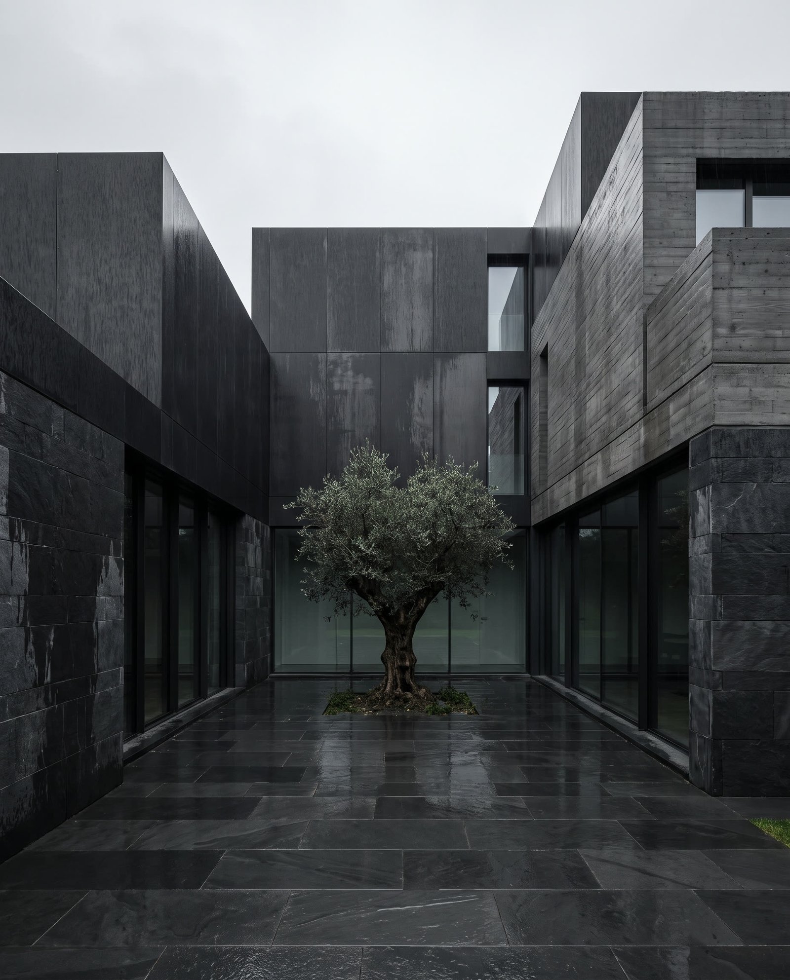 Dark contemporary residence in Milan with black steel and board-formed concrete facade.